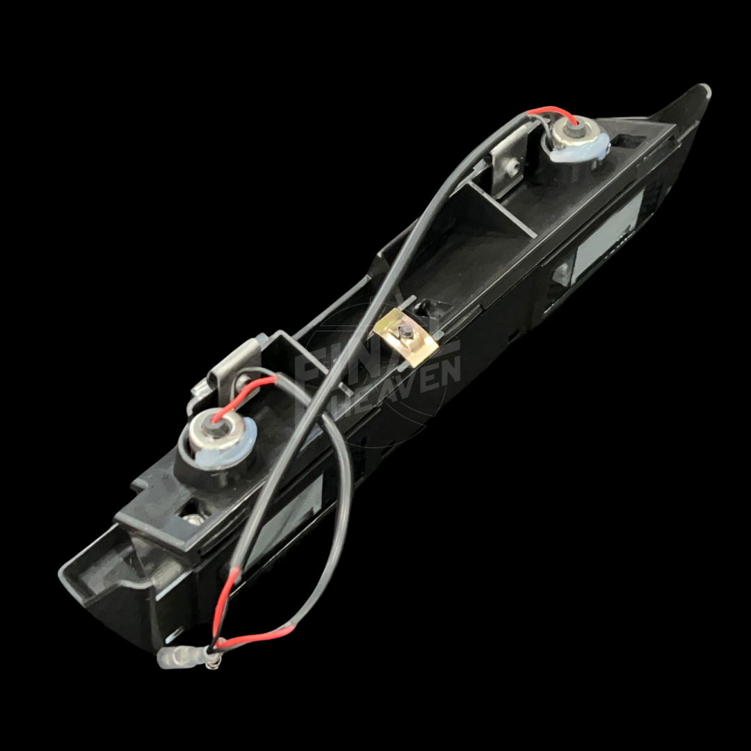 A grey license plate lamp for a Datsun 240Z