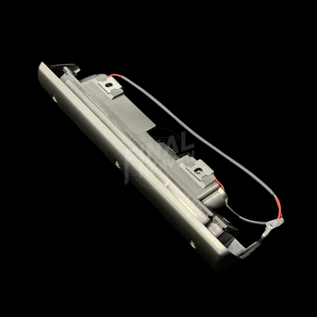 A grey license plate lamp for a Datsun 240Z