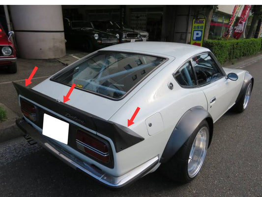 A white 240ZG car with a Marugen Shokai rear 3 piece spoiler installed, shown from a rear angle with red arrows indicating the spoiler's outline.