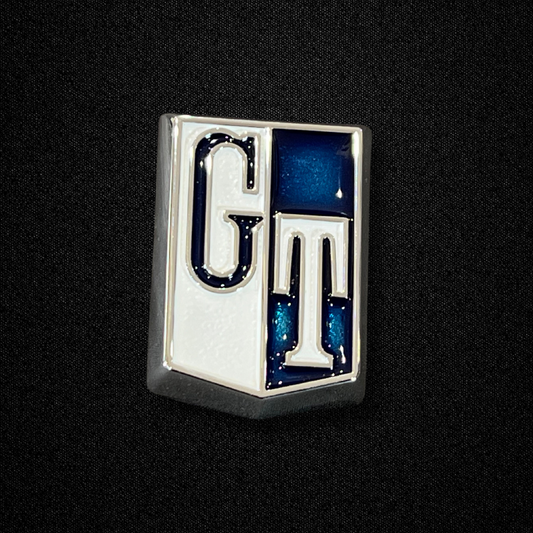 A blue fender emblem for a GC10 Nissan Skyline 2000GT Hakosuka produced by MSpeed
