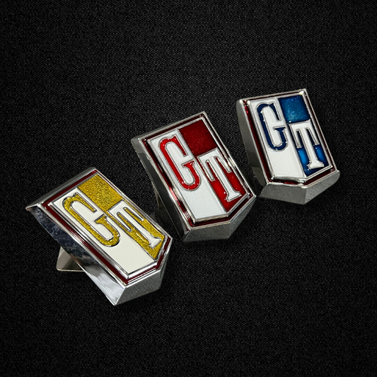 A gold fender emblem for a KGC10 Nissan Skyline 2000GT-X Hakosuka produced by MSpeed