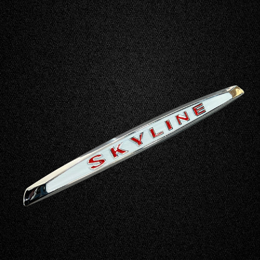 A red trunk emblem for a KPGC10 Nissan Skyline 2000GT Hakosuka produced by MSpeed