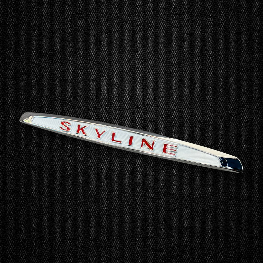 A red trunk emblem for a KPGC10 Nissan Skyline 2000GT Hakosuka produced by MSpeed