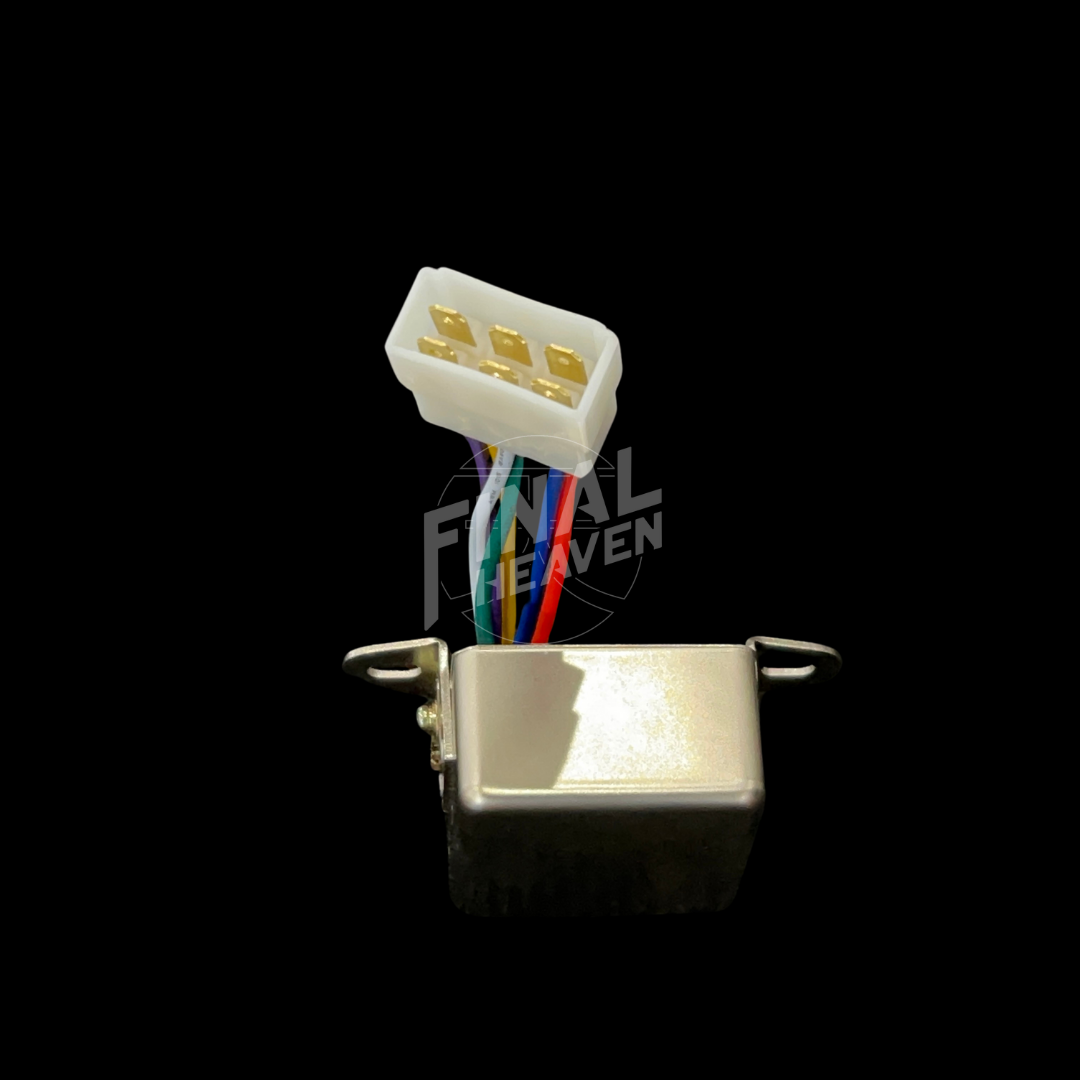 A silver headlight relay with a white connector and multicolored wires for a Nissan Skyline KGC10 or Hakosuka
