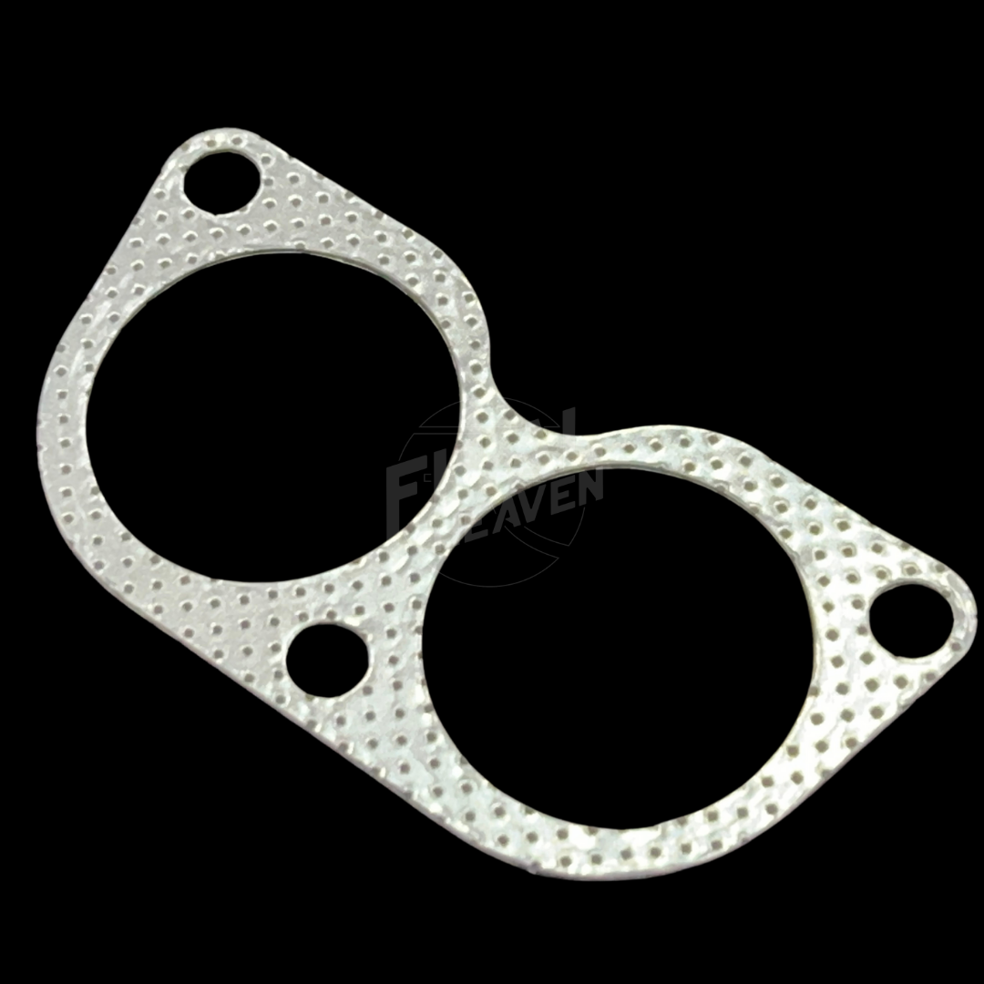 A silver engine exhaust manifold gasket for an L28 powered car such as a Nissan Skyline KGC10 Hakosuka