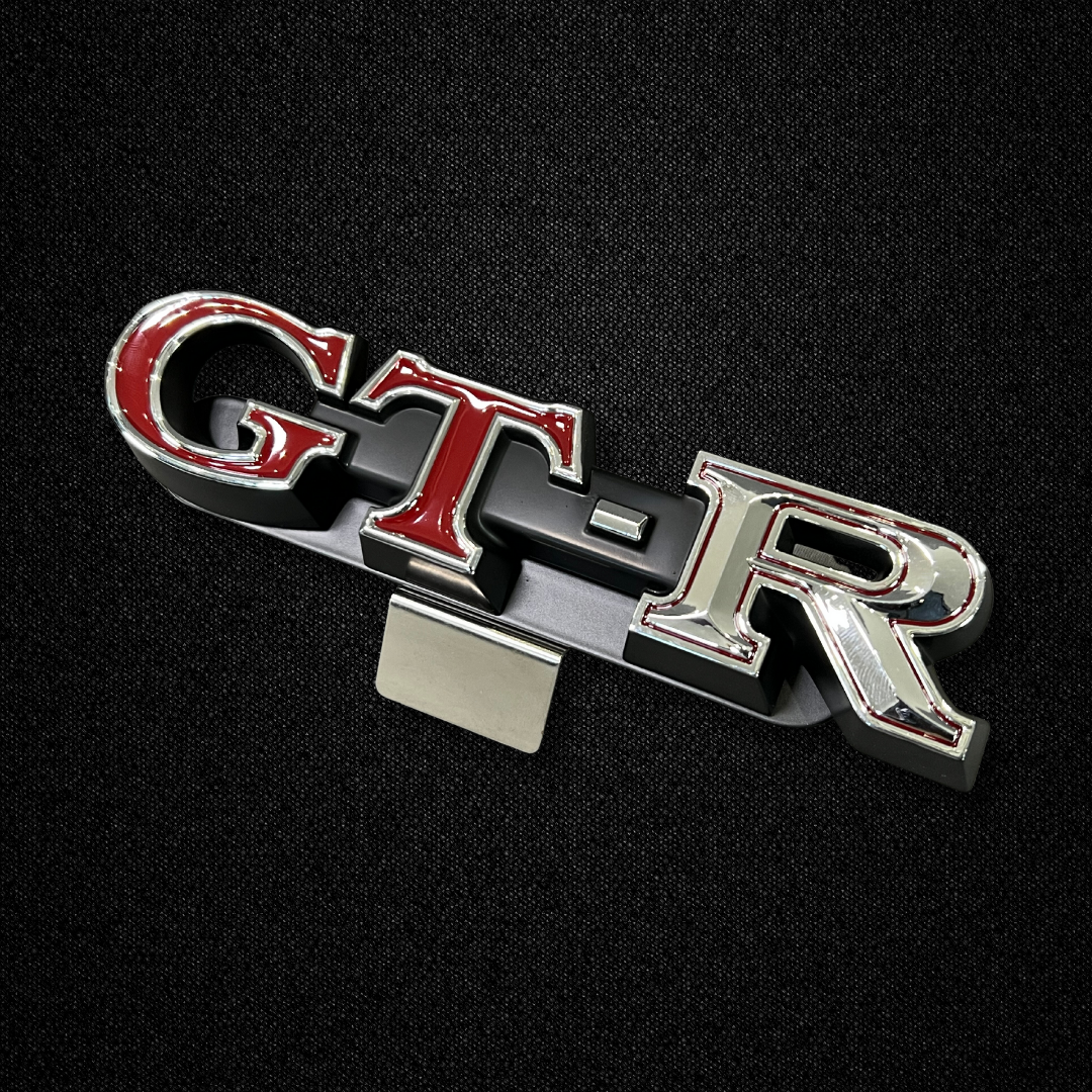 A GT-R front grille emblem for a KGC10 Nissan Skyline 2000GT Hakosuka produced by MSpeed