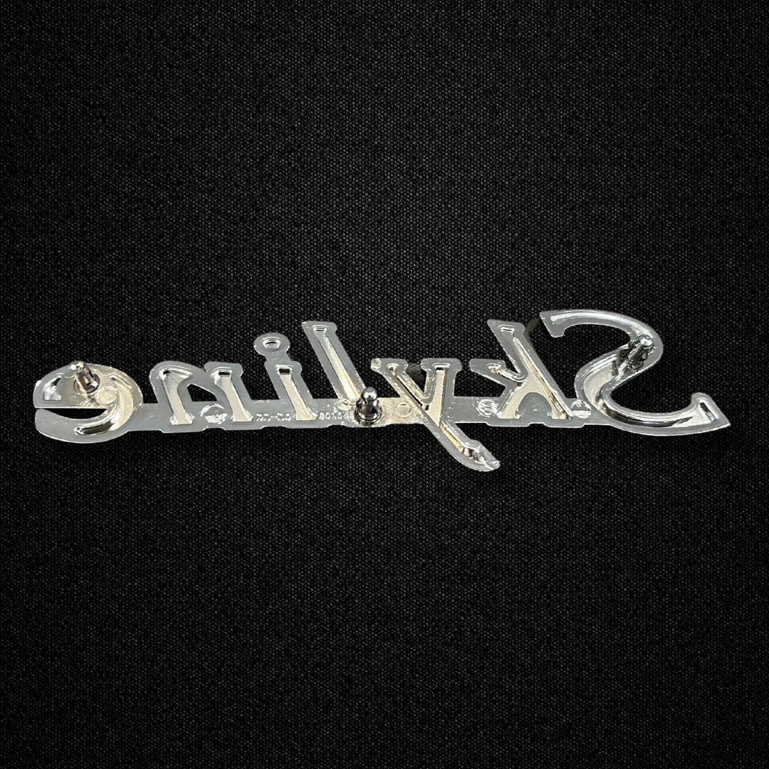 A SKYLINE front fender emblem for a GC10 Nissan Skyline 2000GT Hakosuka produced by MSpeed