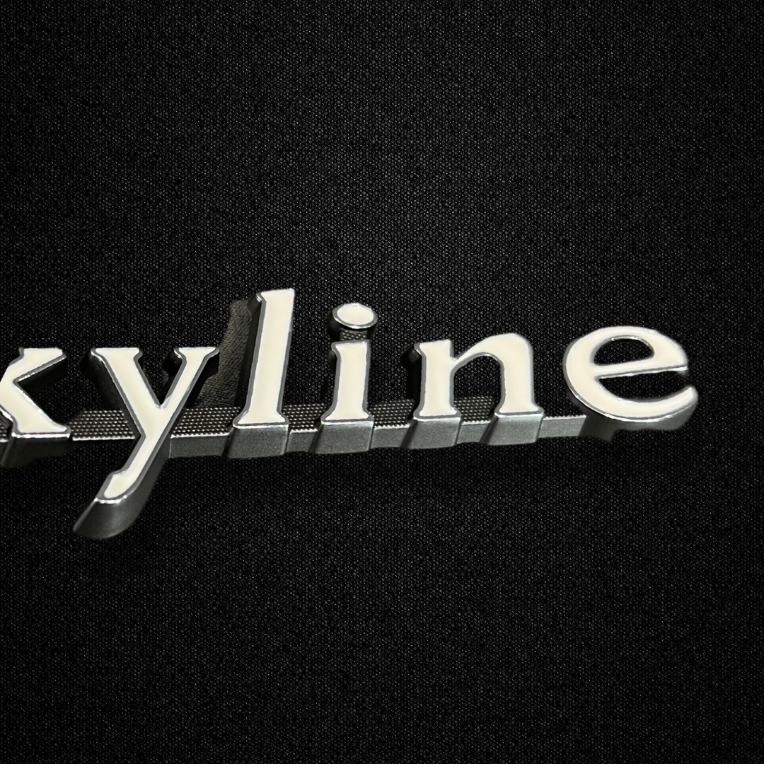 A SKYLINE front fender emblem for a GC10 Nissan Skyline 2000GT Hakosuka produced by MSpeed