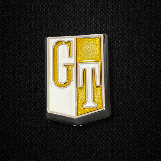 A gold fender emblem for a GC10 Nissan Skyline 2000GT-X Hakosuka produced by MSpeed