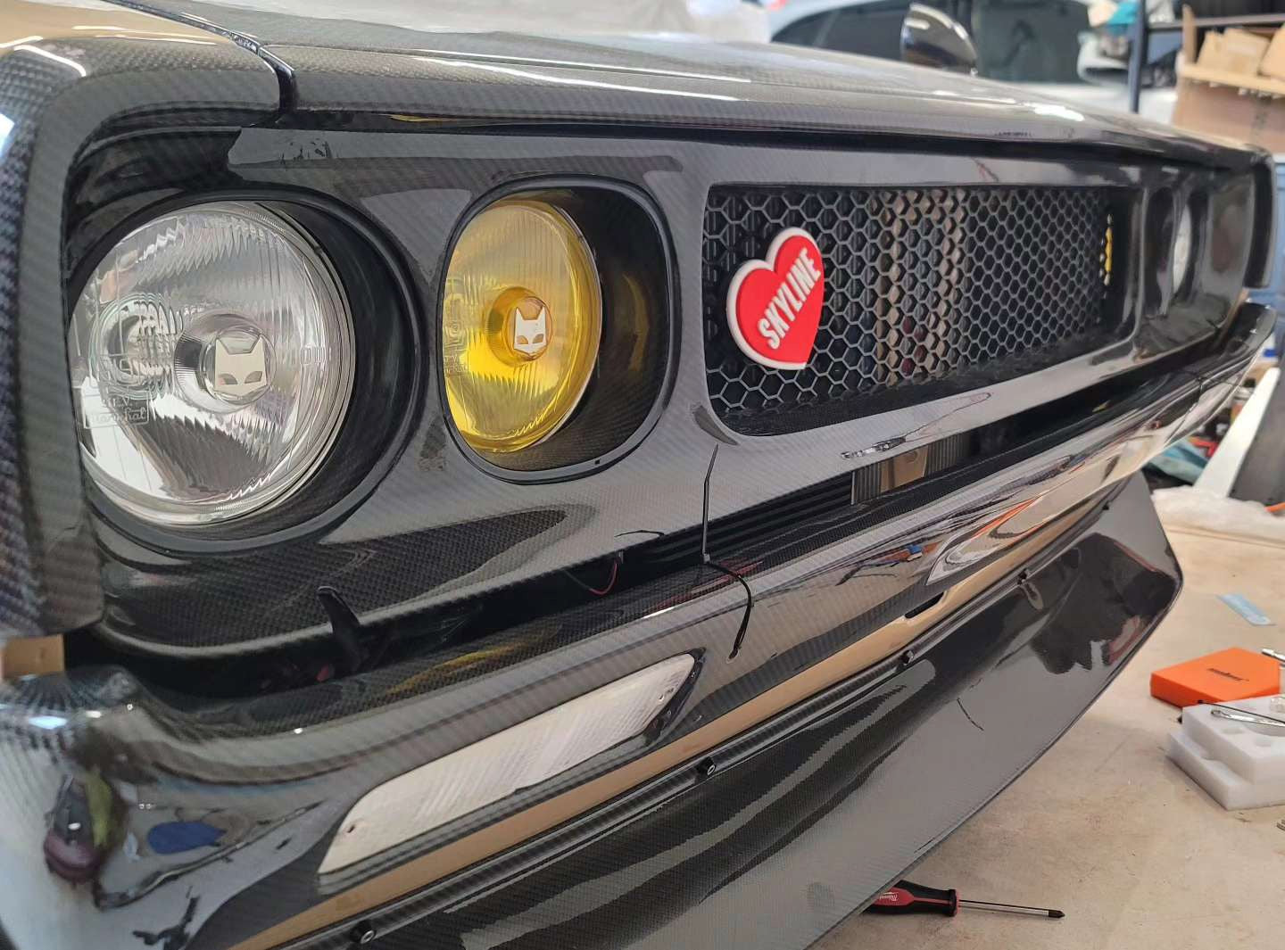 A Nissan Kenmeri KGC110 with Yellow and Clear 130mm SEV Marchal headlights